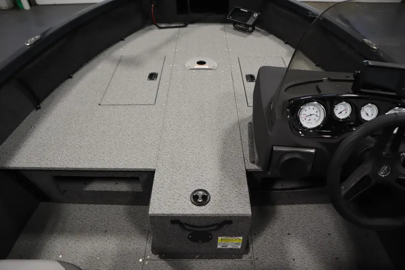 Slide: The Image of 2024 Crestliner 1750 Hawk boat interior with dashboard and storage compartments. - 18