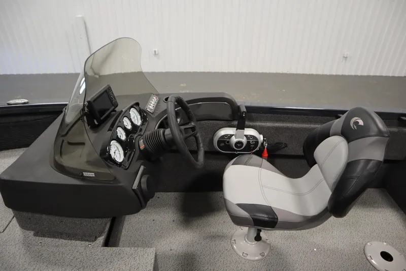 Slide: The Image of 2024 Crestliner 1750 Hawk boat interior with steering console and cushioned seat. - 22