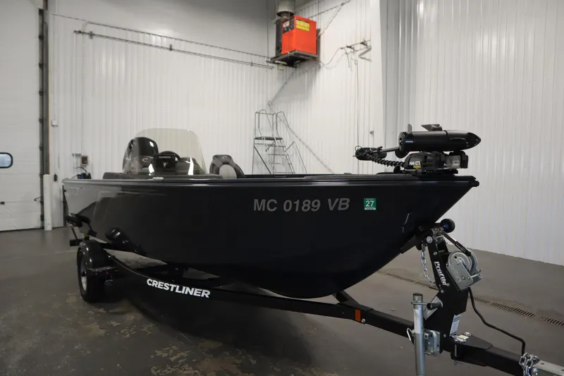 Slide: The Image of 2024 Crestliner 1750 Hawk boat in a garage, showcasing sleek design and modern features. - 3