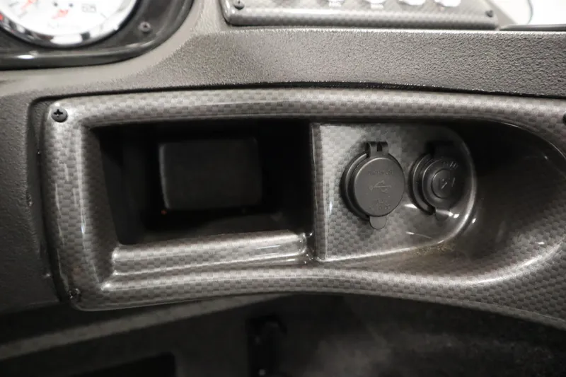 Slide: The Image of Dashboard of 2024 Crestliner 1750 Hawk boat with power outlets and carbon fiber finish. - 30