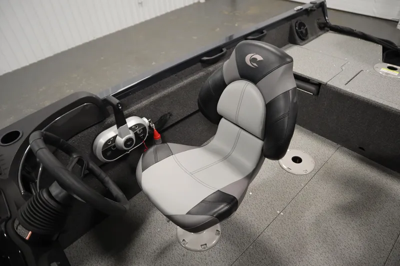 Slide: The Image of 2024 Crestliner 1750 Hawk boat interior with steering wheel and cushioned seat. - 33
