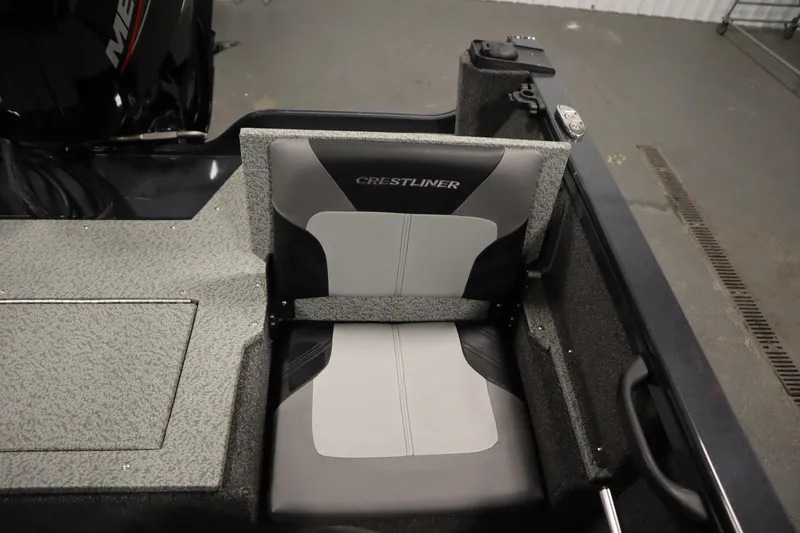 Slide: The Image of 2024 Crestliner 1750 Hawk boat seat, gray and black design, in a garage setting. - 37