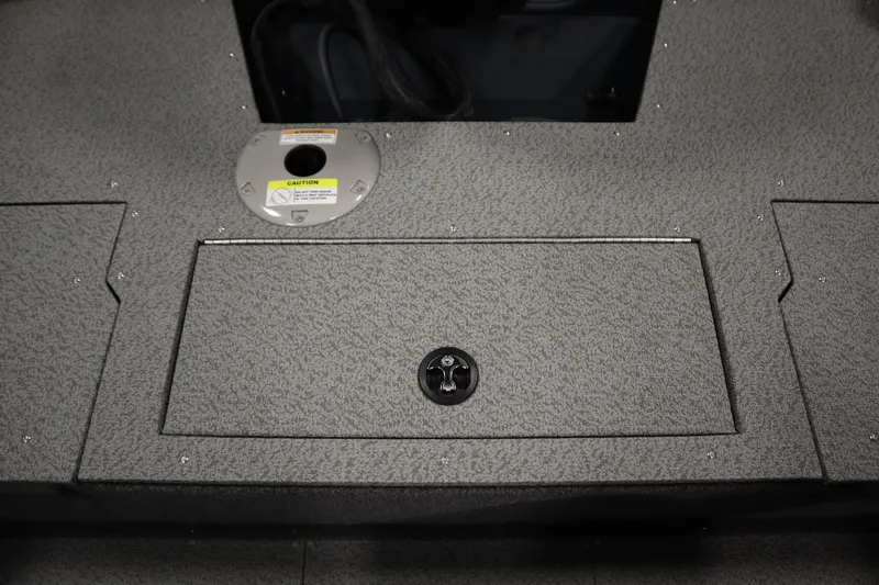 Slide: The Image of 2024 Crestliner 1750 Hawk boat deck with storage compartment and caution label. - 38