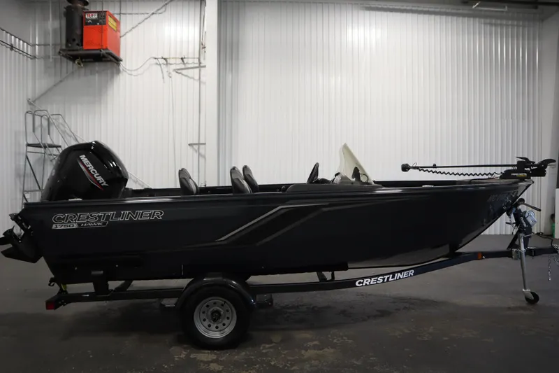 Slide: The Image of 2024 Crestliner 1750 Hawk fishing boat in a garage, side view. - 4