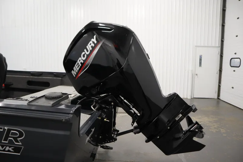 Slide: The Image of 2024 Crestliner 1750 Hawk with Mercury outboard motor in a garage setting. - 41