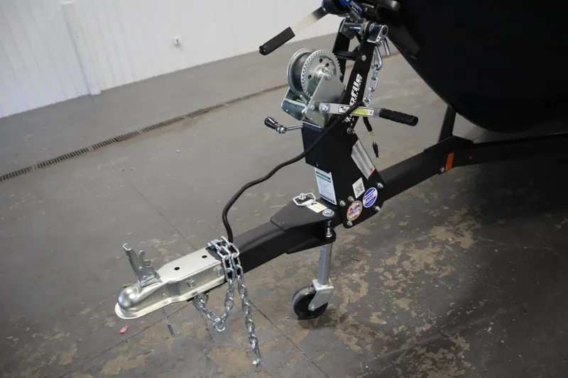 Slide: The Image of Trailer hitch and winch of 2024 Crestliner 1750 Hawk boat in a garage setting. - 44