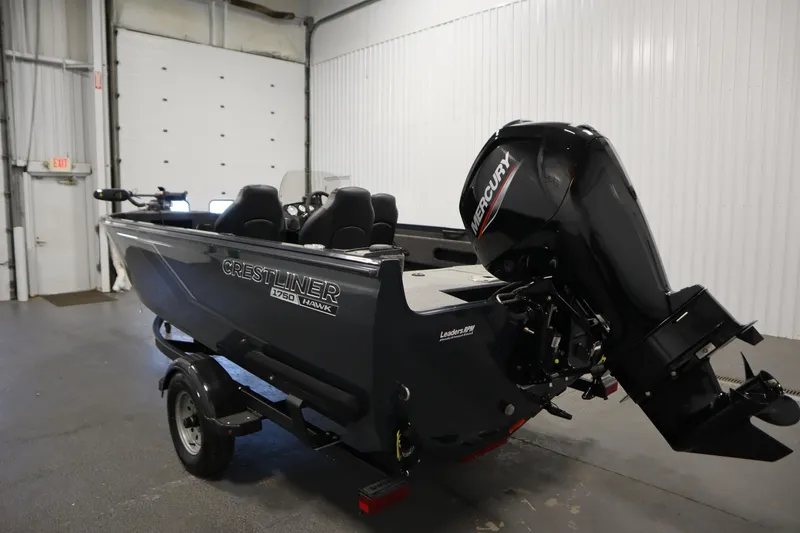 Slide: The Image of 2024 Crestliner 1750 Hawk boat with Mercury outboard motor in a garage setting. - 7