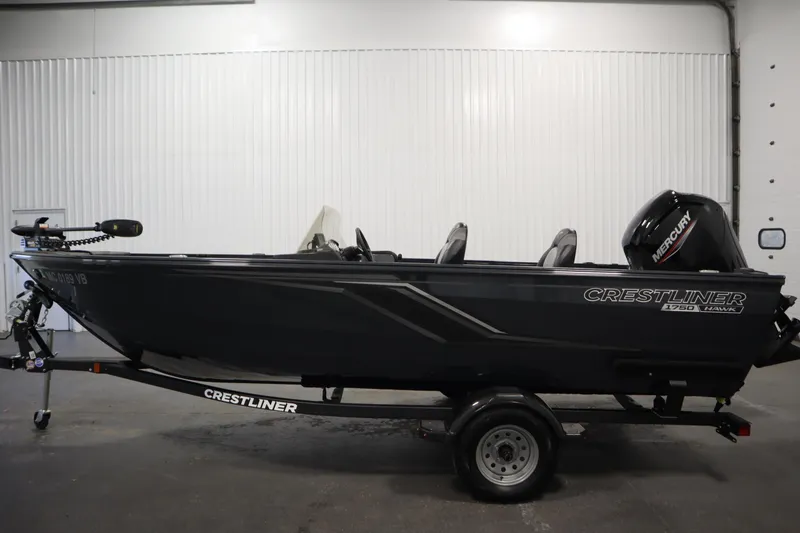 Slide: The Image of 2024 Crestliner 1750 Hawk fishing boat on trailer in indoor setting. - 8