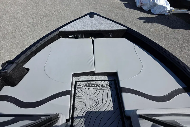 Slide: The Image of 2026 Smoker Craft Adventurer 188 DC boat interior with cushioned seating and branded flooring. - 13