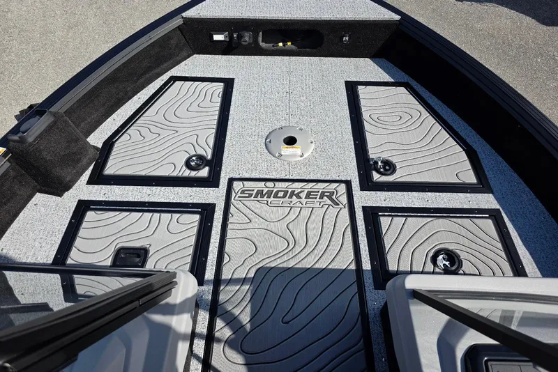 Slide: The Image of 2026 Smoker Craft Adventurer 188 DC boat deck with storage compartments and textured flooring. - 14
