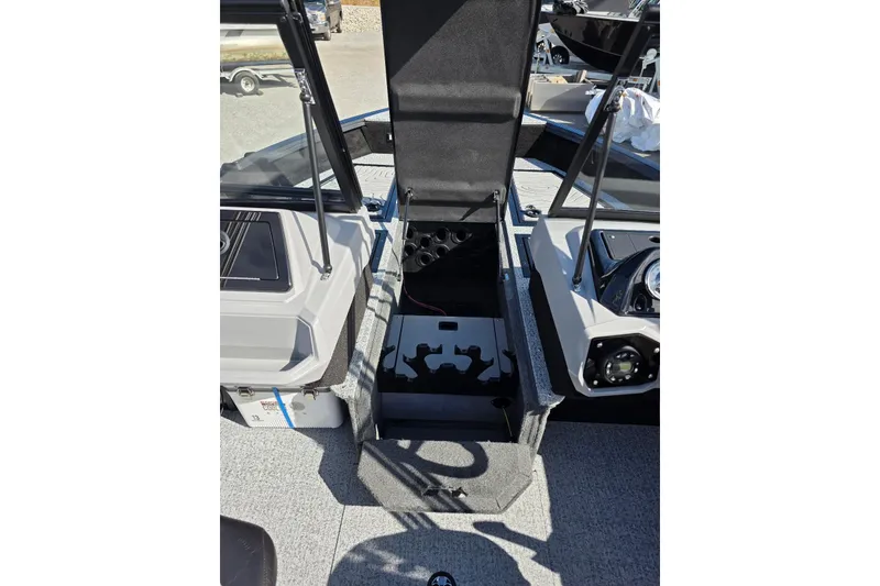 Slide: The Image of 2026 Smoker Craft Adventurer 188 DC boat interior with open storage compartment. - 17