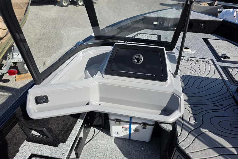 Slide: The Image of 2026 Smoker Craft Adventurer 188 DC boat interior with storage and cooler. - 19