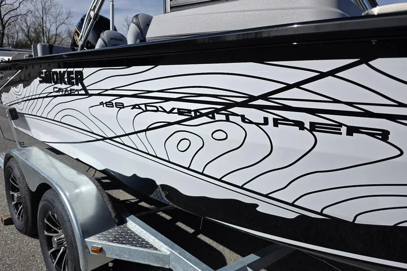 Slide: The Image of 2026 Smoker Craft Adventurer 188 DC boat with sleek design on trailer. - 2