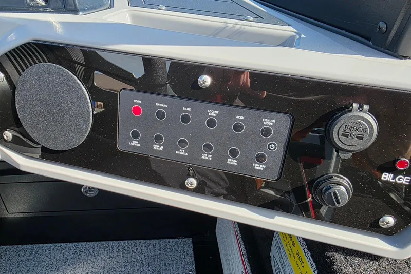 Slide: The Image of Control panel of 2026 Smoker Craft Adventurer 188 DC boat with various switches. - 22