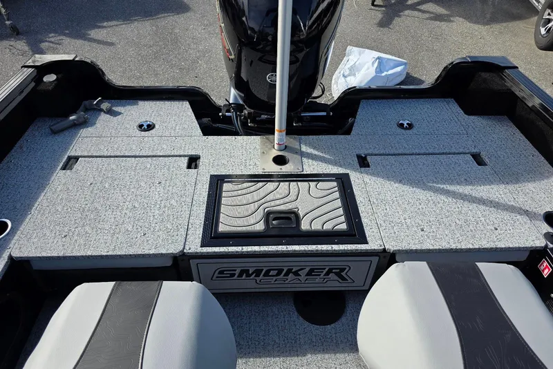 Slide: The Image of 2026 Smoker Craft Adventurer 188 DC boat interior with seating and storage compartments. - 26