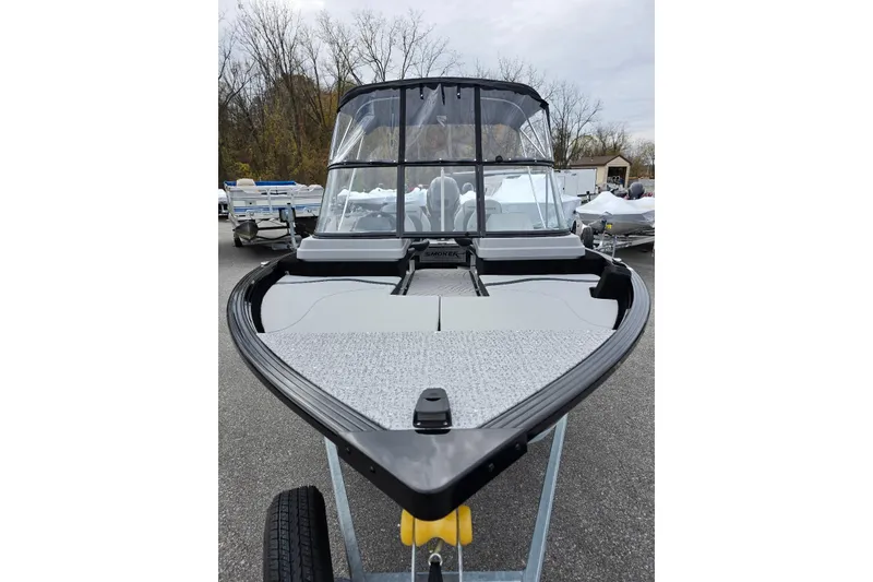 Slide: The Image of 2026 Smoker Craft Adventurer 188 DC boat on trailer, parked outdoors. - 8