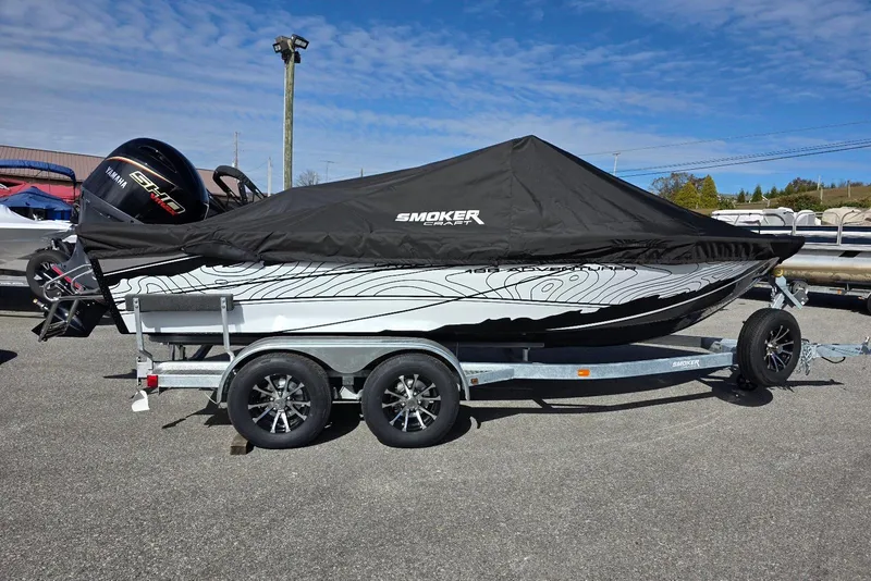 Slide: The Image of 2026 Smoker Craft Adventurer 188 DC boat on trailer, covered, with Yamaha engine. - 9