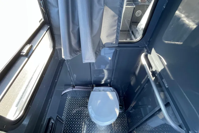 Slide: The Image of 2026 Hewescraft 250 Alaskan ET HT boat interior with compact bathroom and toilet. - 11