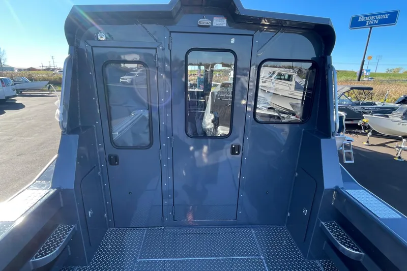 Slide: The Image of 2026 Hewescraft 250 Alaskan ET HT boat exterior with blue finish and diamond plate flooring. - 12