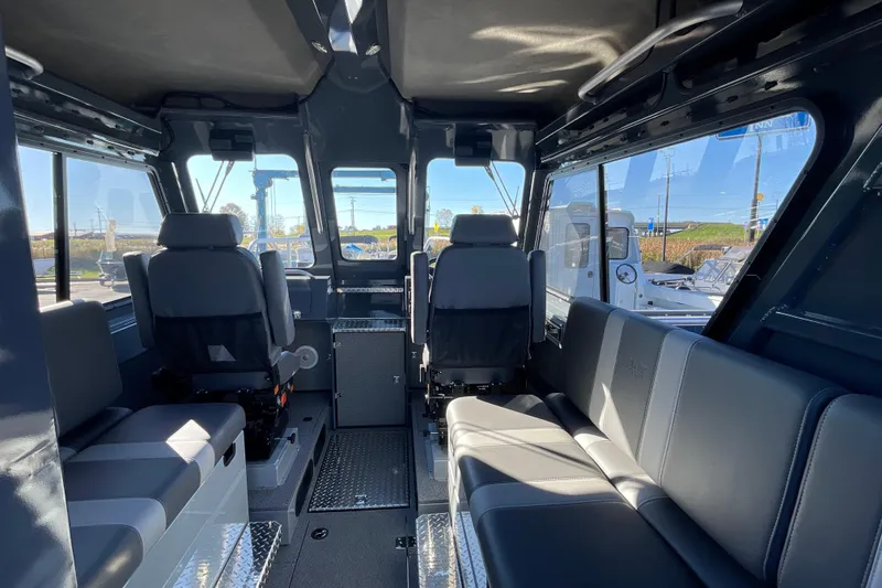 Slide: The Image of Interior of 2026 Hewescraft 250 Alaskan ET HT boat, featuring spacious seating and modern design. - 13