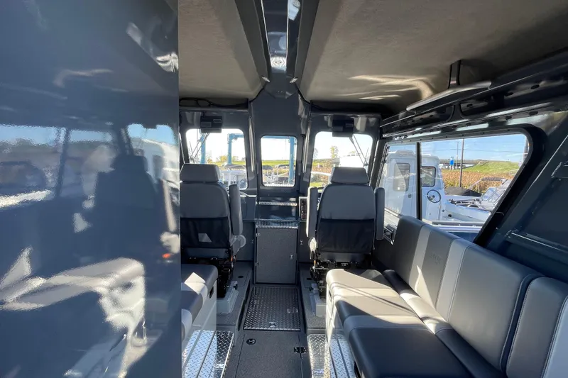 Slide: The Image of Interior of 2026 Hewescraft 250 Alaskan ET HT boat, featuring spacious seating and modern design. - 14