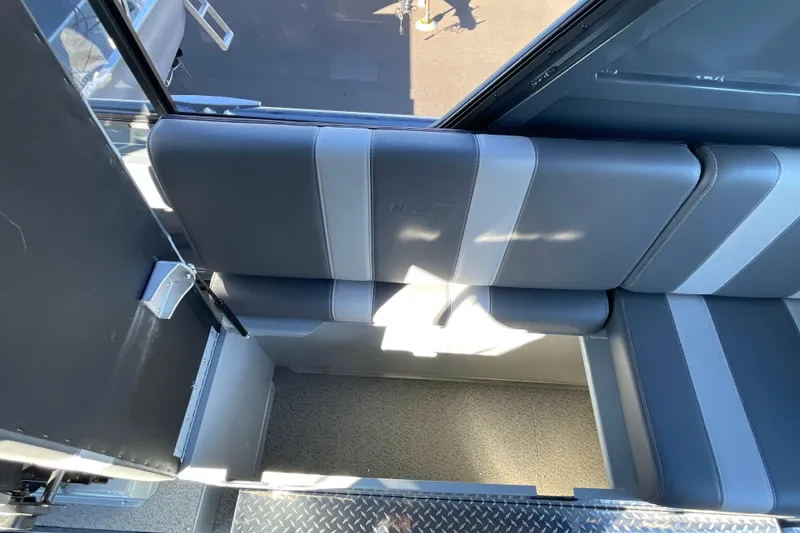 Slide: The Image of 2026 Hewescraft 250 Alaskan ET HT boat interior seating, featuring gray upholstery and storage compartment. - 16