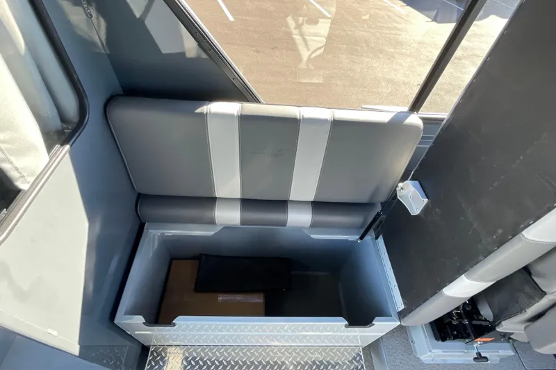 Slide: The Image of 2026 Hewescraft 250 Alaskan ET HT interior storage compartment with cushioned seating. - 18