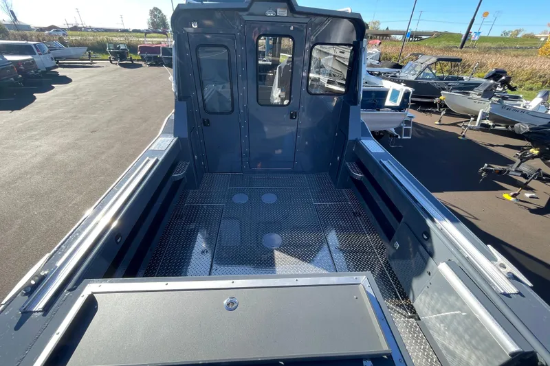 Slide: The Image of 2026 Hewescraft 250 ALASKAN ET HT boat interior, showcasing spacious deck and cabin area. - 2