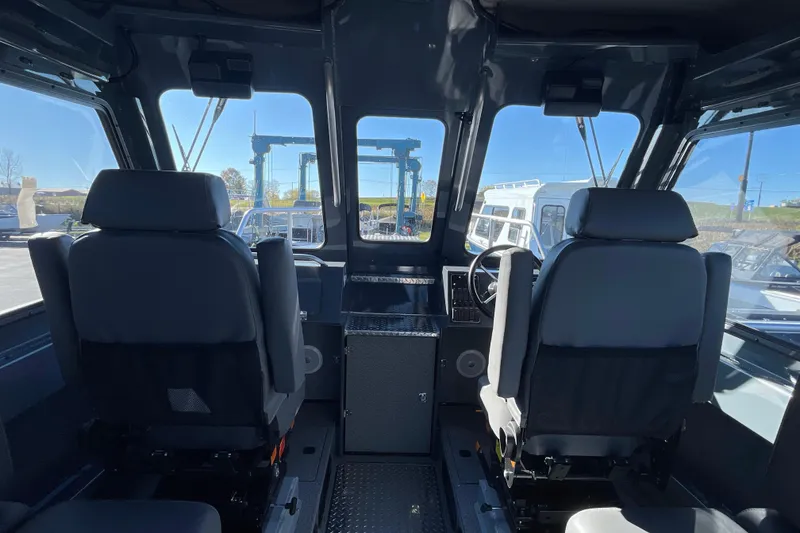 Slide: The Image of Interior of 2026 Hewescraft 250 Alaskan ET HT boat, featuring dual seats and control panel. - 20