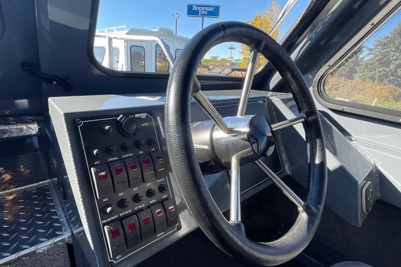 Slide: The Image of Steering wheel and control panel of 2026 Hewescraft 250 Alaskan ET HT boat. - 24