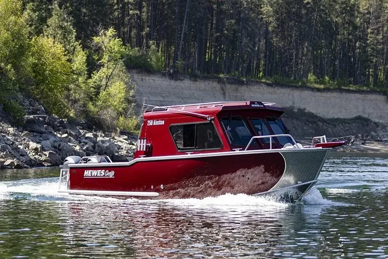 Slide: The Image of 2026 Hewescraft 250 Alaskan ET HT boat cruising on a scenic river. - 39