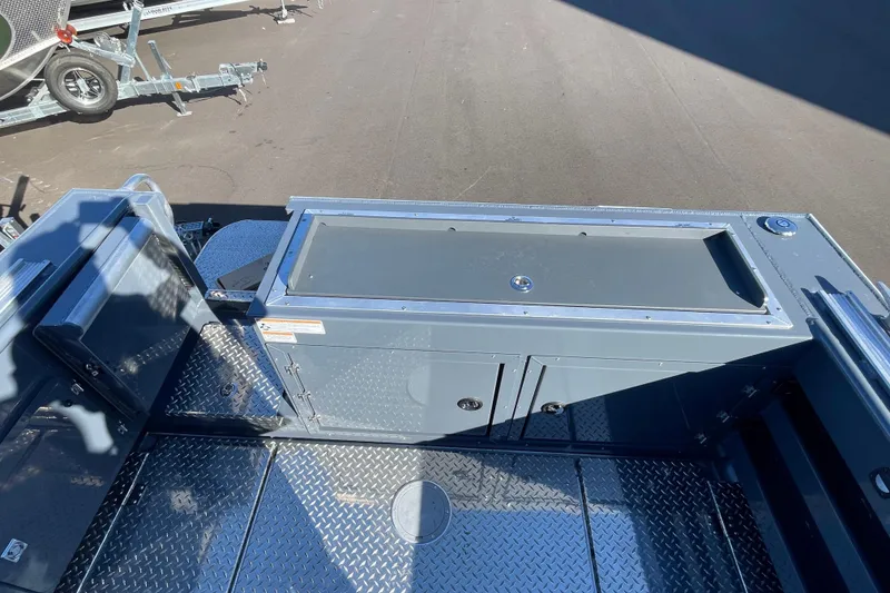 Slide: The Image of 2026 Hewescraft 250 Alaskan ET HT boat interior with storage compartment and diamond plate flooring. - 4