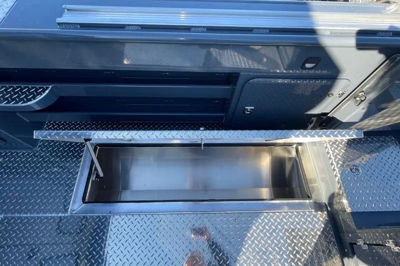 Slide: The Image of 2026 Hewescraft 250 Alaskan ET HT boat storage compartment with diamond plate flooring. - 6