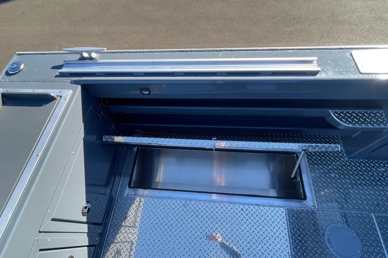 Slide: The Image of 2026 Hewescraft 250 Alaskan ET HT boat interior with storage compartment and diamond plate flooring. - 7