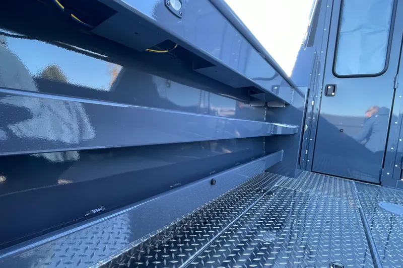 Slide: The Image of 2026 Hewescraft 250 Alaskan ET HT boat interior with metallic flooring and storage compartments. - 9