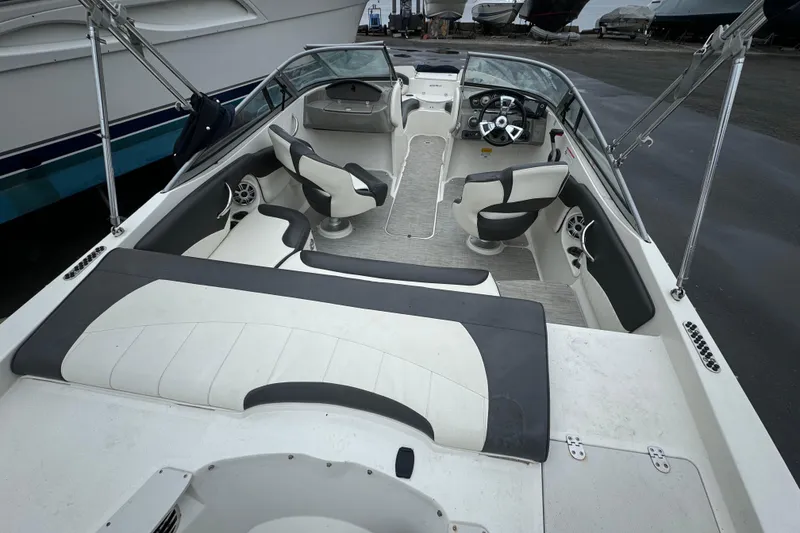 Slide: The Image of 2017 Stingray 204 LR boat interior with seating and steering wheel. - 10