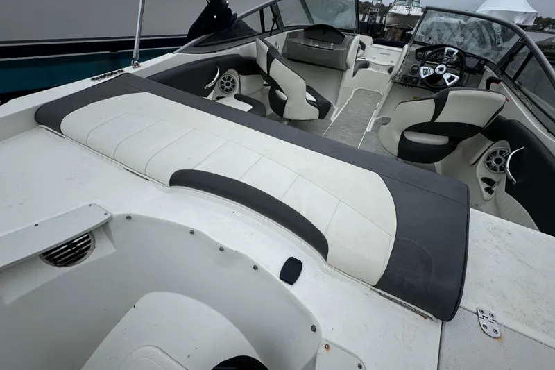 Slide: The Image of 2017 Stingray 204 LR boat interior with seating and steering console. - 11