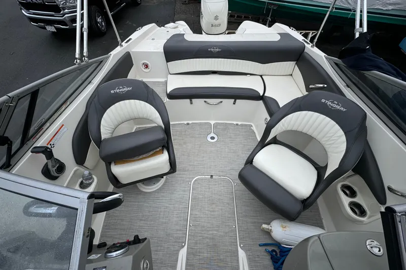 Slide: The Image of 2017 Stingray 204 LR boat interior with seating and steering wheel. - 8