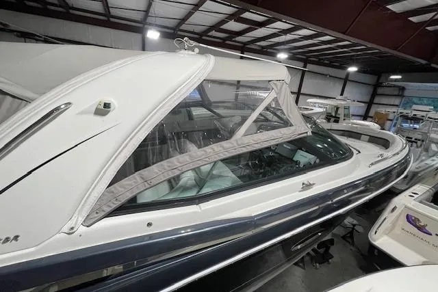 Slide: The Image of 2017 Formula 350 Crossover Bowrider in indoor storage, showcasing sleek design and protective cover. - 13