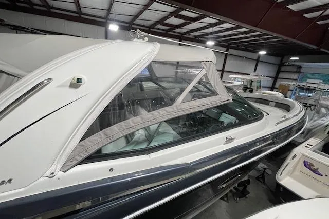 Slide: The Image of 2017 Formula 350 Crossover Bowrider in indoor storage, showcasing sleek design and protective cover. - 14