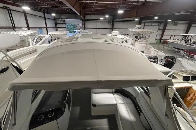 Slide: The Image of 2017 Formula 350 Crossover Bowrider in indoor storage, showcasing spacious seating and canopy. - 20