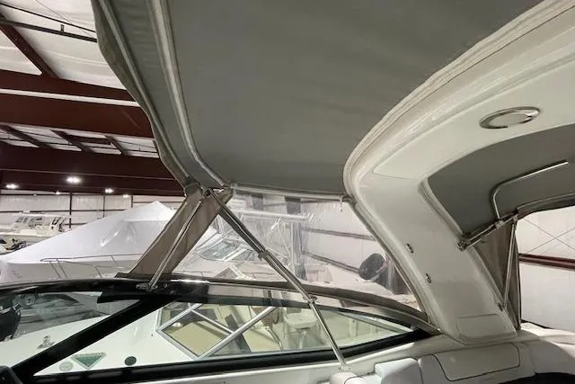 Slide: The Image of 2017 Formula 350 Crossover Bowrider interior with canopy in a storage facility. - 21