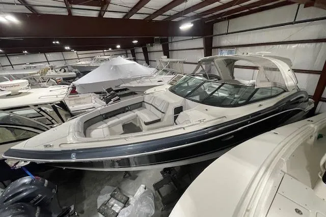 Slide: The Image of 2017 Formula 350 Crossover Bowrider in indoor storage, showcasing sleek design and spacious seating. - 3