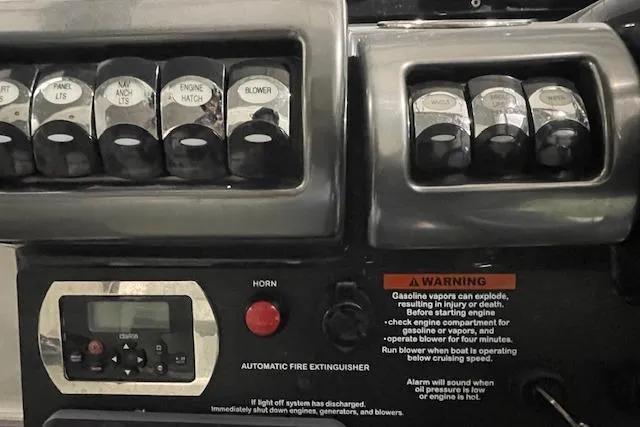 Slide: The Image of Control panel of a 2017 Formula 350 Crossover Bowrider with switches and warning labels. - 51