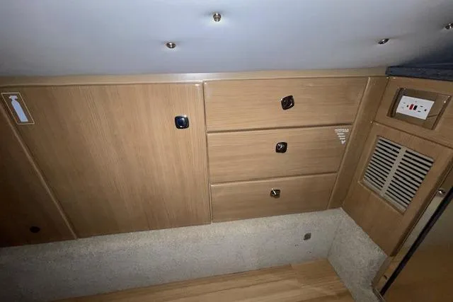 Slide: The Image of 2017 Formula 350 Crossover Bowrider interior with wooden cabinets and drawers. - 69