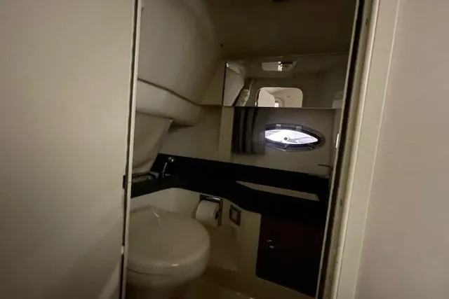 Slide: The Image of 2017 Formula 350 Crossover Bowrider interior bathroom with toilet and porthole window. - 71