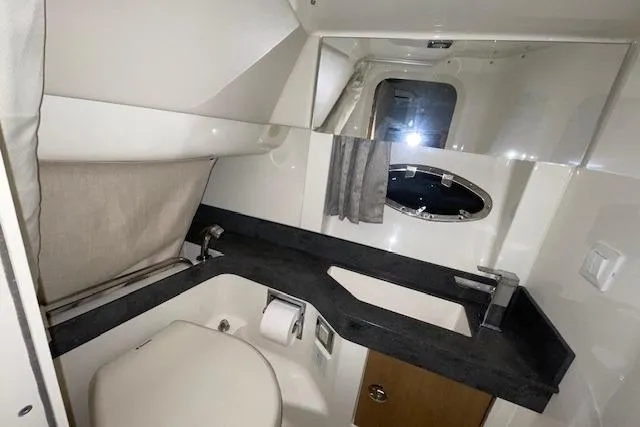 Slide: The Image of 2017 Formula 350 Crossover Bowrider bathroom with modern fixtures and porthole window. - 73