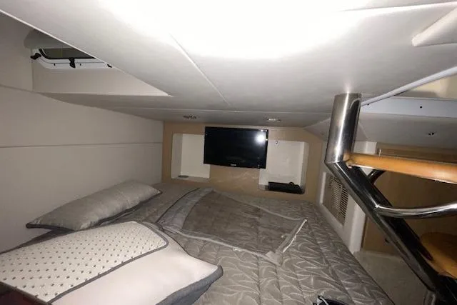 Slide: The Image of 2017 Formula 350 Crossover Bowrider cabin with bed, TV, and modern interior design. - 80