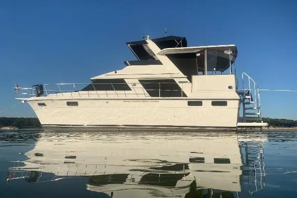 The Image of 1986 Carver 42 Aft Cabin Motor Yacht on calm water, side view. - 0