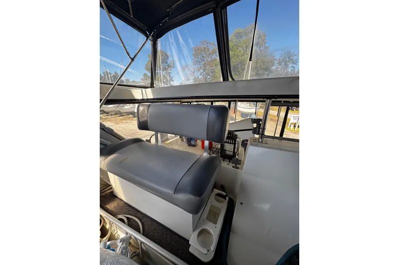 Slide: The Image of Captain's seat on 1986 Carver 42 Aft Cabin Motor Yacht, featuring a sleek design. - 24